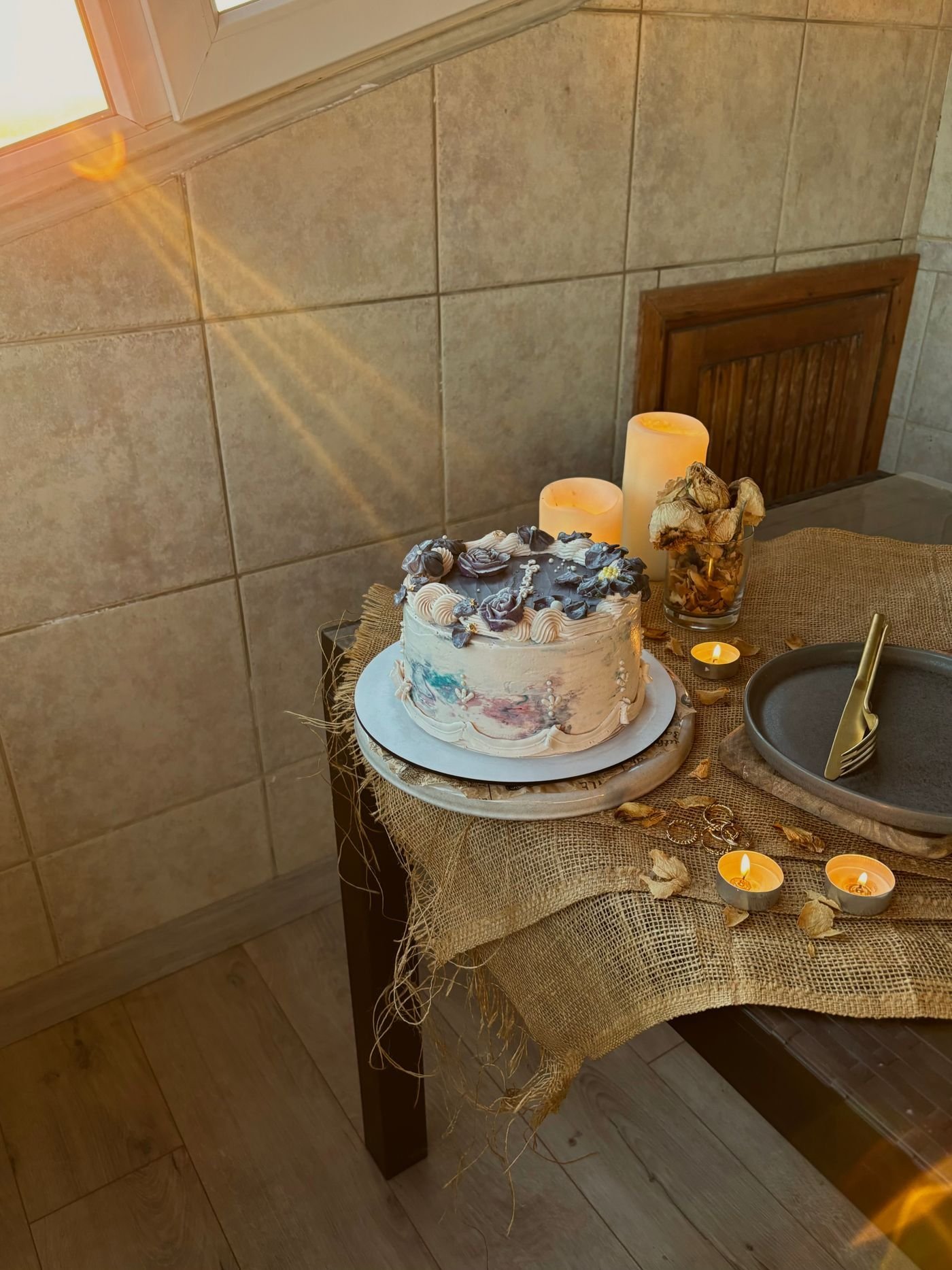 A rustic celebration cake lit by warm sunlight